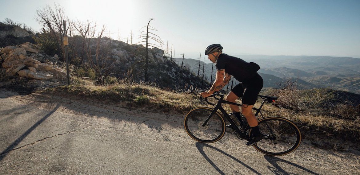 Cyclist climbing mountain on a road bike