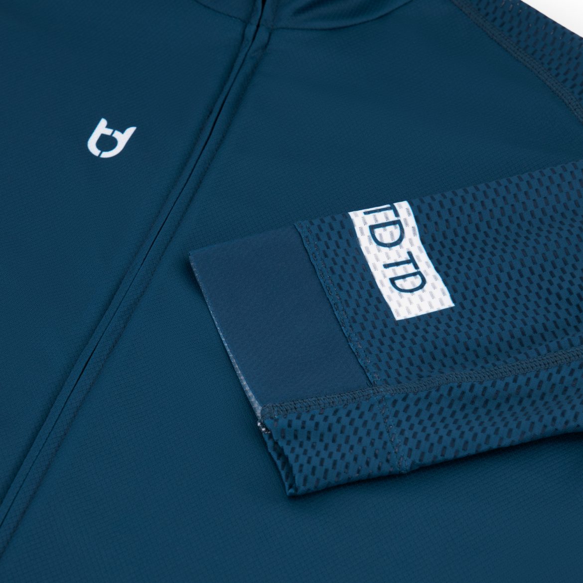 Mesh sleeve detail photo of a dark blue TD sportswear cycling jersey