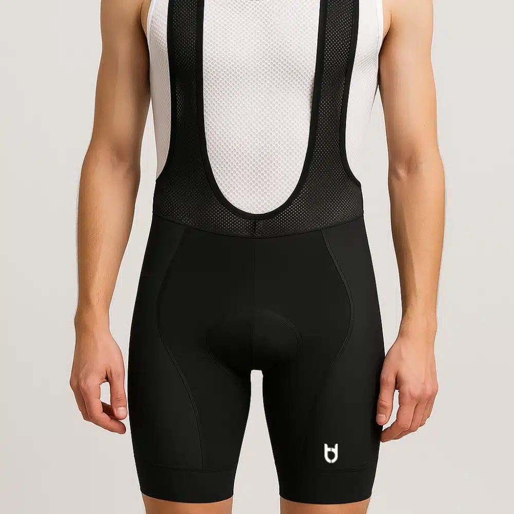Rear view of male cyclist in full cycling outfit showing back pockets and bib structure.